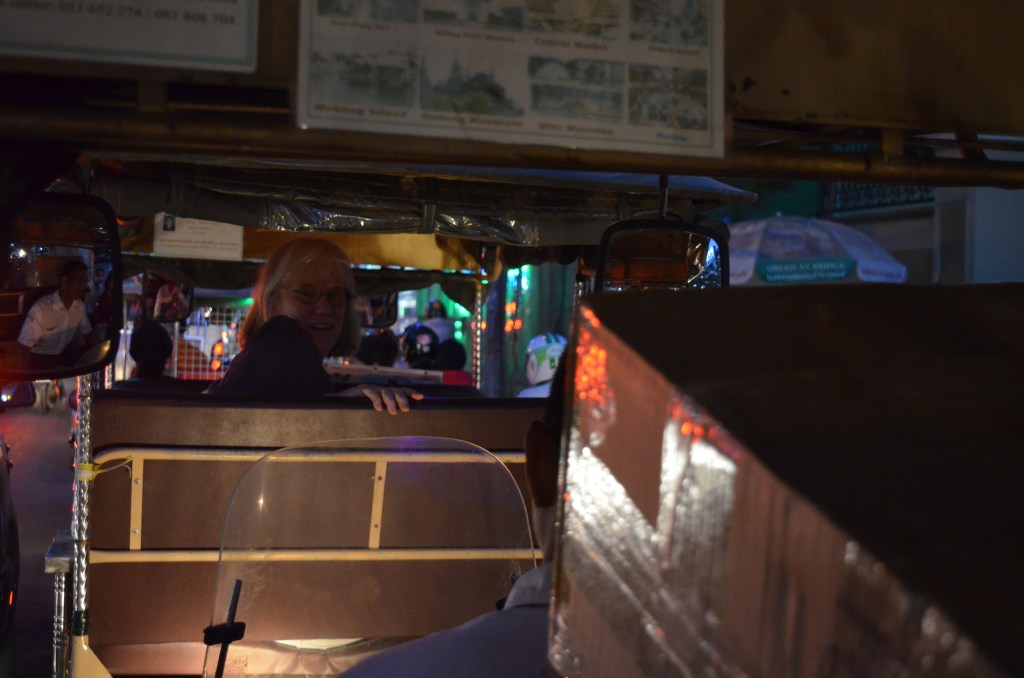 riding into town with Brendan's guitar and Narda in Tuk Tuk in front