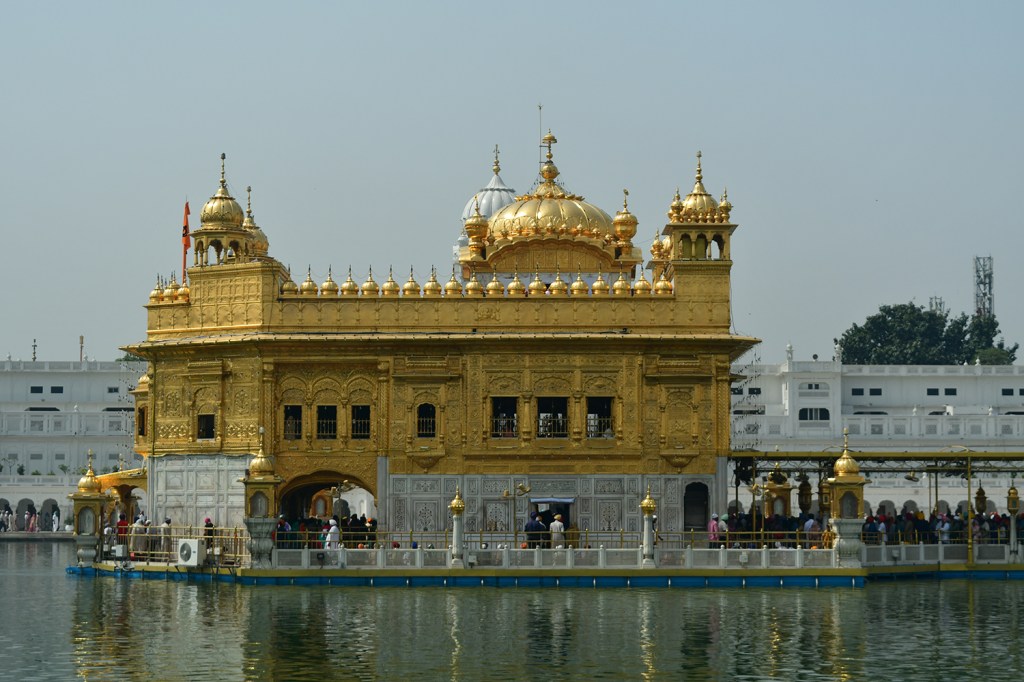 Sri Harmandir Sahib ("The abode of God"), also known as Darbar Sahib, (Punjabi pronunciation: [dəɾbɑɾ sɑhɪb]),informally referred to as the Golden Temple, is a Gurdwara located in the city of Amritsar, Punjab, India. It is one of the most revered spiritual sites of Sikhism.<br /> Amritsar (literally, the tank of nectar of immortality) was founded in 1577 by the fourth Sikh guru, Guru Ram Das.The fifth Sikh Guru, Guru Arjan, designed Harmandir Sahib to be built in the center of this tank, and upon its construction, installed the Adi Granth, the holy scripture of Sikhism, inside Harmandir Sahib.The Harmandir Sahib complex is also home to the Akal Takht (the throne of the timeless one, constituted by the Sixth Guru, Guru Hargobind). While the Harmandir Sahib is regarded as the abode of God's spiritual attribute, the Akal Takht is the seat of God's temporal authority.<br /> The construction of Harmandir Sahib was intended to build a place of worship for men and women from all walks of life and all religions to worship God equally.The four entrances (representing the four directions) to get into the Harmandir Sahib also symbolise the openness of the Sikhs towards all people and religions. Over 100,000 people visit the shrine daily for worship, and also partake jointly in the free community kitchen and meal (Langar) regardless of any distinctions, a tradition that is a hallmark of all Sikh Gurdwaras. Read some more at https://en.wikipedia.org/wiki/Golden_Temple, I did.